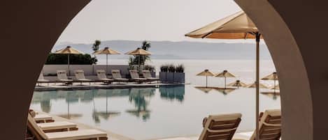 Seasonal outdoor pool, open 10:00 AM to 6:00 PM, pool umbrellas