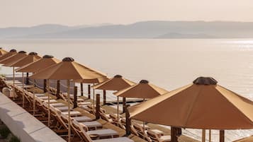 On the beach, sun-loungers, beach umbrellas, beach towels