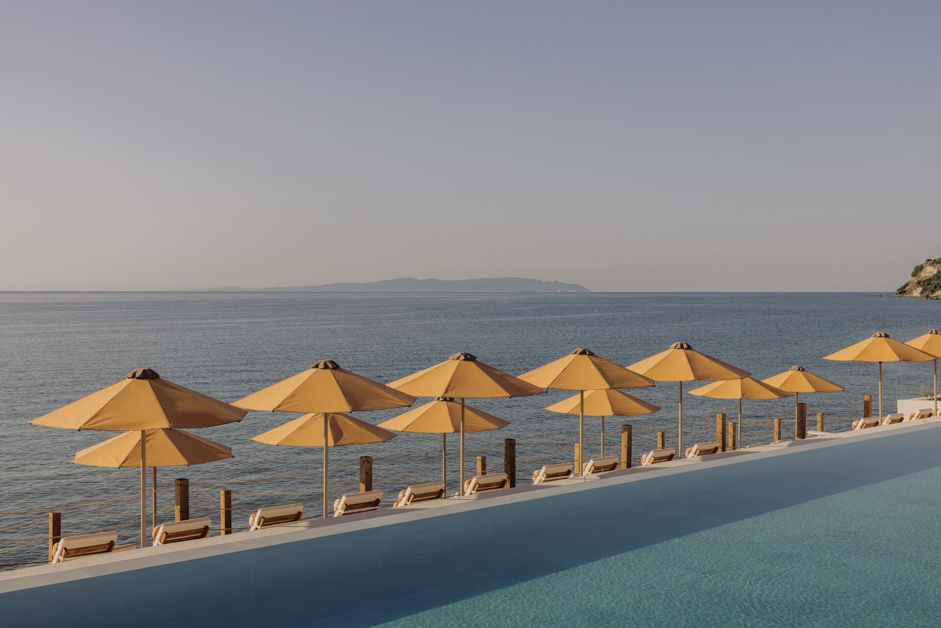 Seasonal outdoor pool, open 10:00 AM to 6:00 PM, pool umbrellas