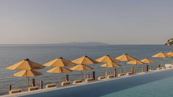 Seasonal outdoor pool, open 10:00 AM to 6:00 PM, pool umbrellas