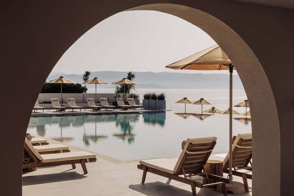 Seasonal outdoor pool, open 10:00 AM to 6:00 PM, pool umbrellas