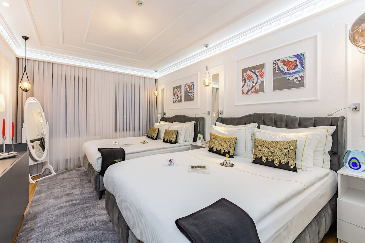 Superior vierpersoonskamer | Een minibar, een kluis op de kamer, verduisterende gordijnen