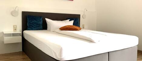 Down comforters, pillowtop beds, in-room safe, desk