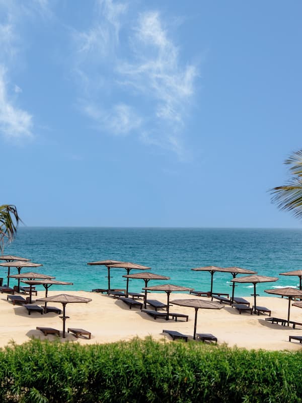 On the beach, white sand, beach umbrellas, beach bar