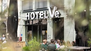 A hotel exterior with outdoor seating and a sign reading "HOTEL Ve". - Hotel Vé (Mechelen)