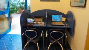 A small workspace with two laptops, a printer, and a map on the wall. - Al Baglio - Affittacamere (Palermo)