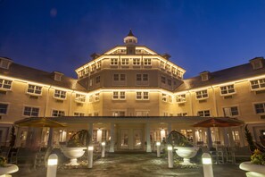 A large, multi-story hotel with a central courtyard, multiple balconies, and a prominent tower. - Cedar Point's Hotel Breakers (Sandusky)