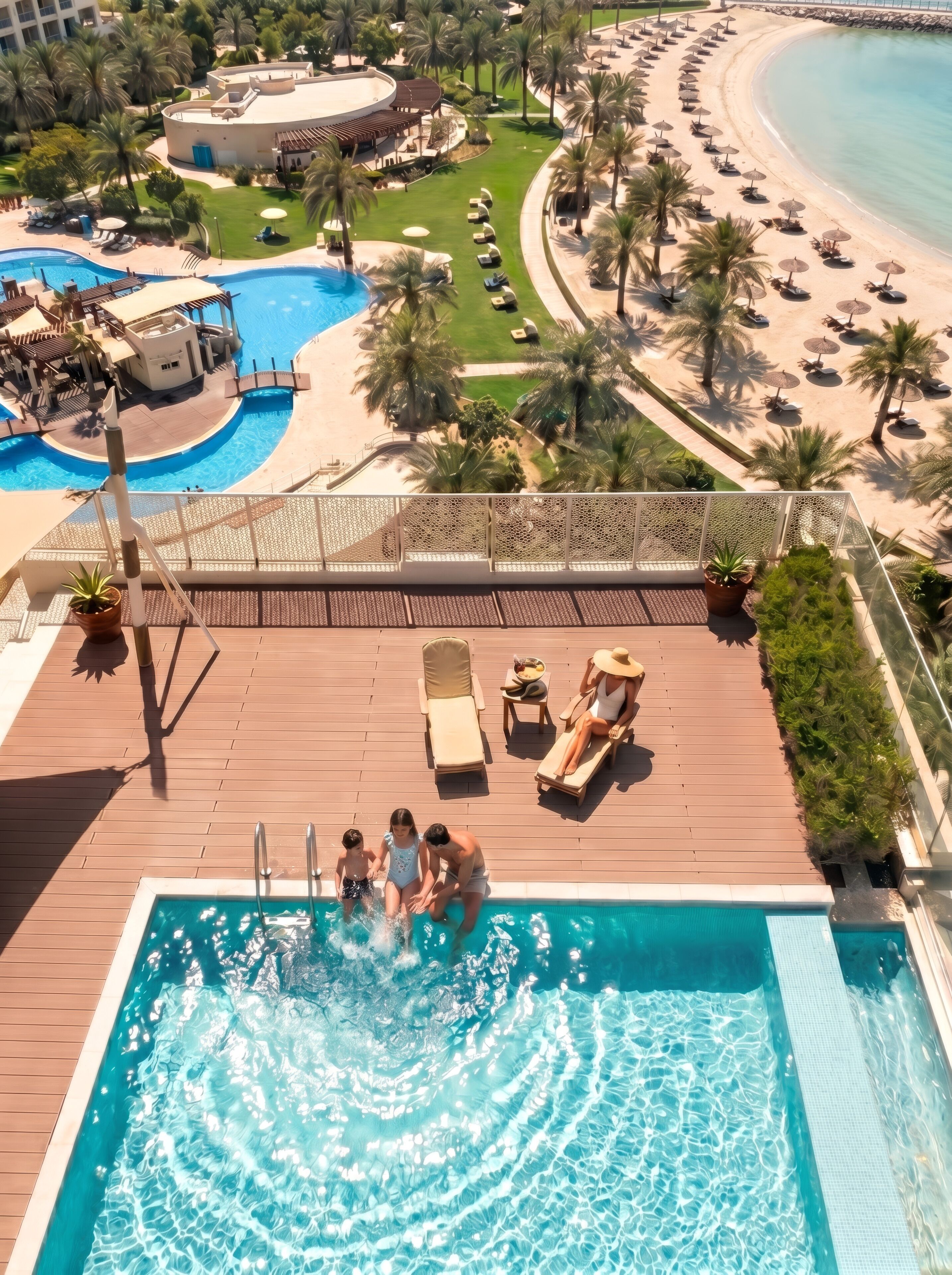 A rooftop pool with a view of a beach and palm trees.