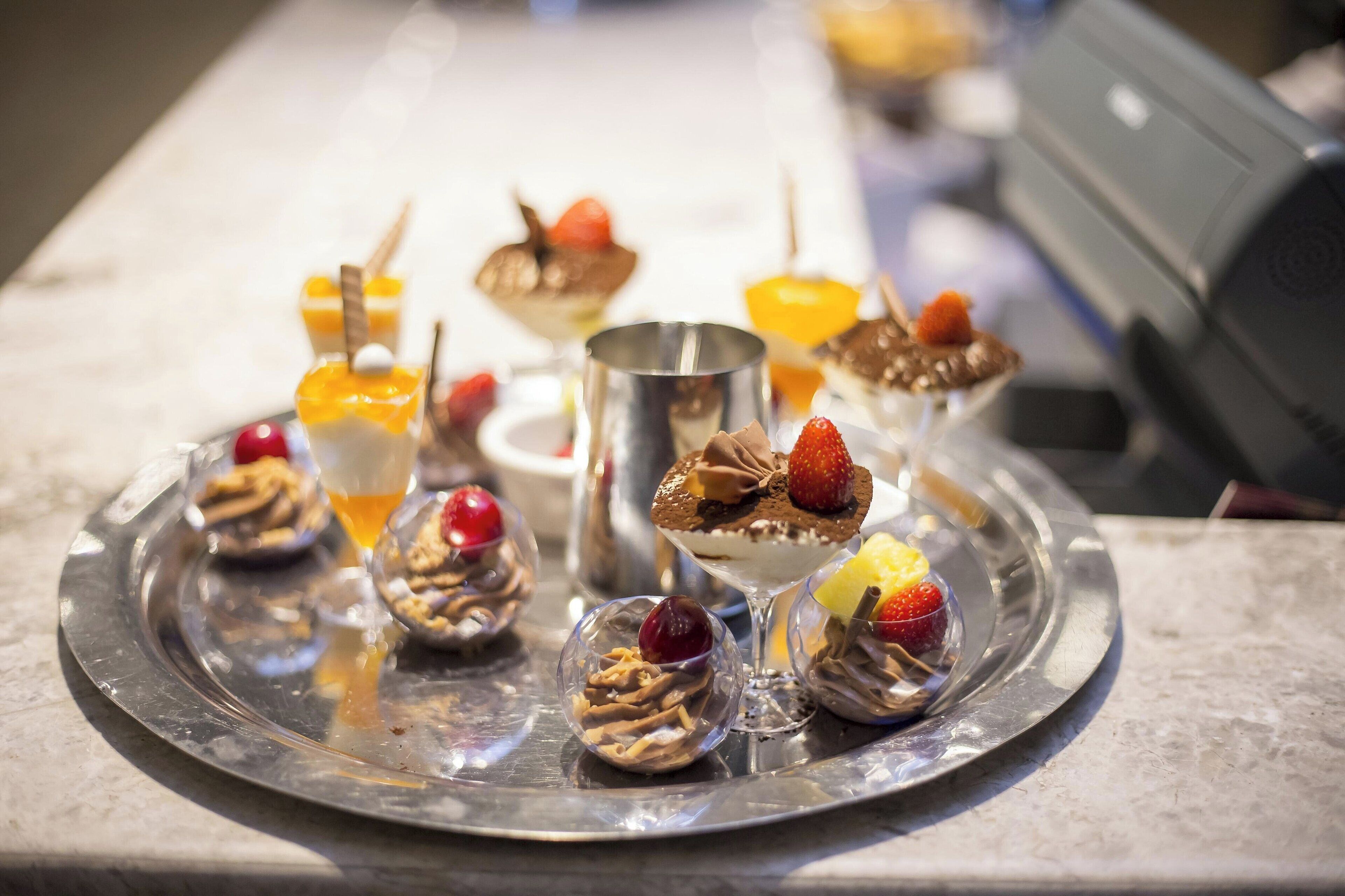 A tray of assorted desserts on a marble countertop.