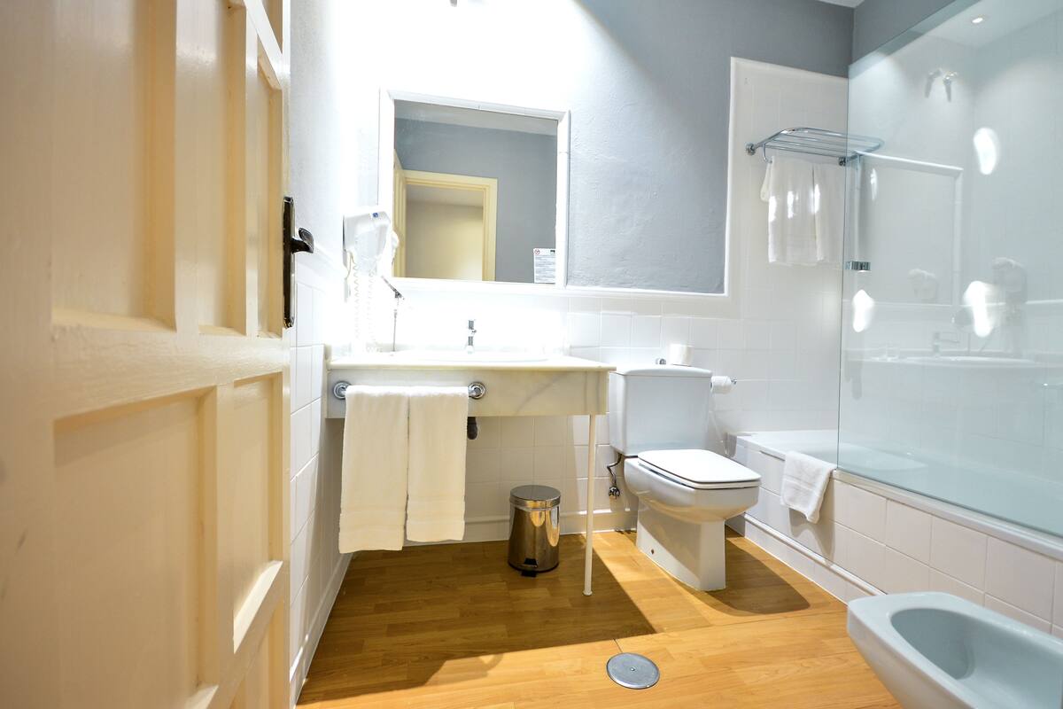 junior suite | bathroom | deep-soaking bathtub, rainfall showerhead, free toiletries, hair dryer