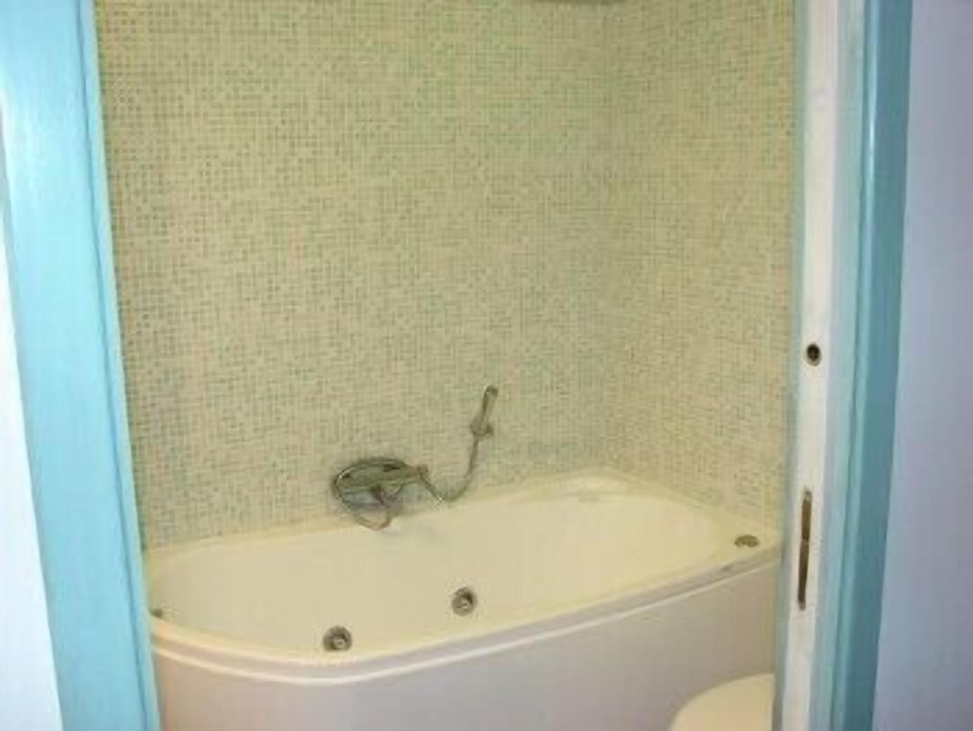 A bathroom with a bathtub, a shower, and a toilet.