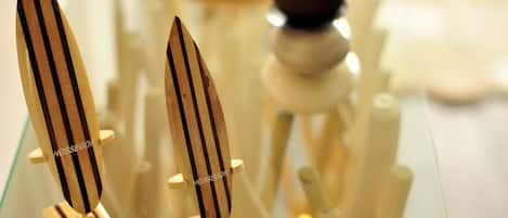 A glass display with wooden objects and a lit candle.