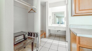 A bathroom with a white sink, mirror, and a towel rack.