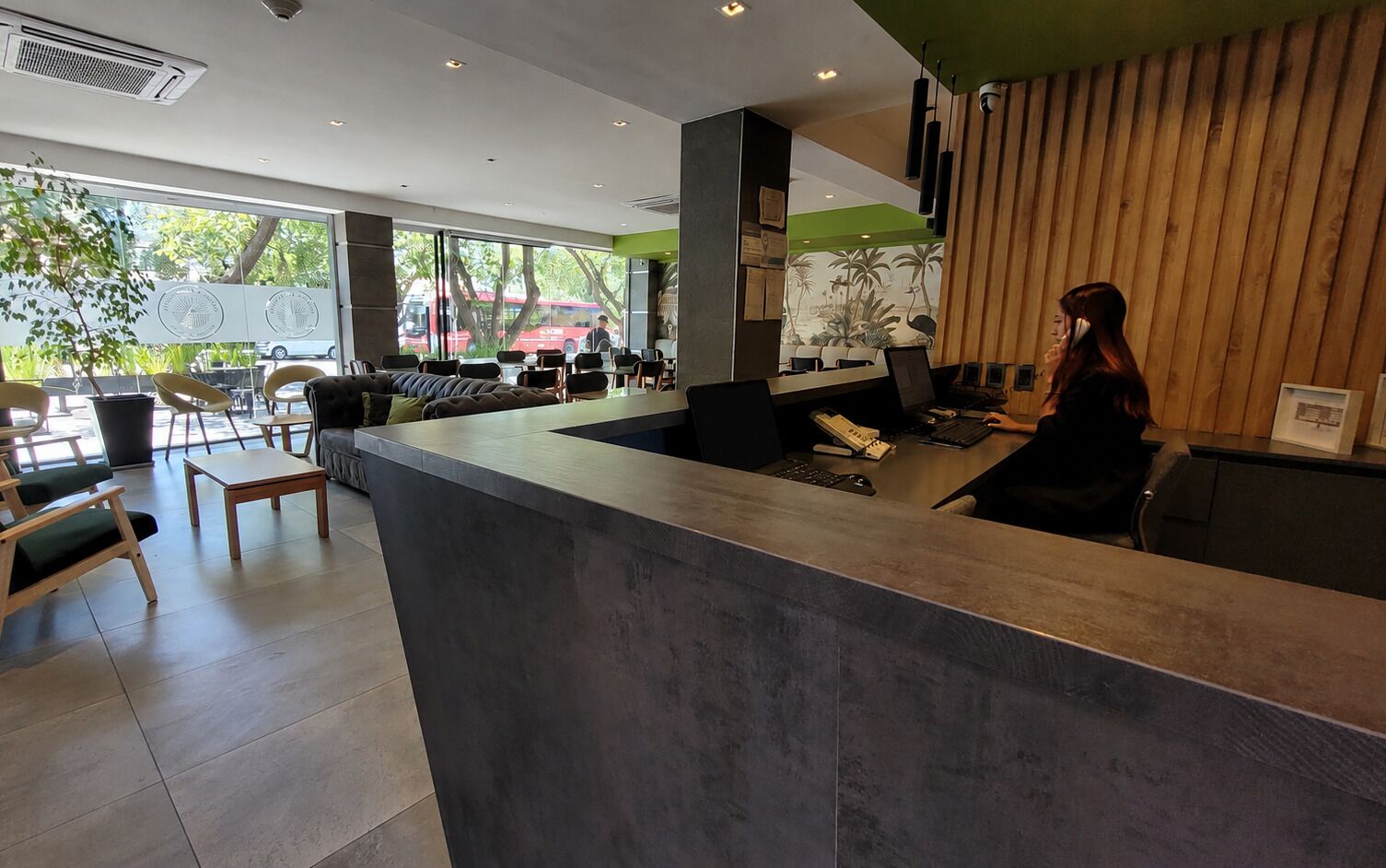 A reception area with a counter, seating, and a view of the outside.