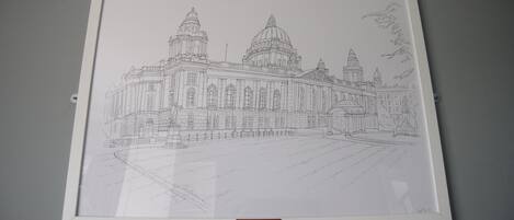A framed architectural drawing of a large, historic building with domes and columns, labeled "BELFAST CITY BALL MUSEUM".