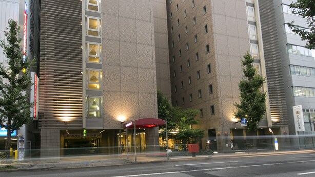 A modern hotel with a prominent entrance, large windows, and a red awning. - Nagoya Sakae Washington Hotel Plaza (Nagoya)