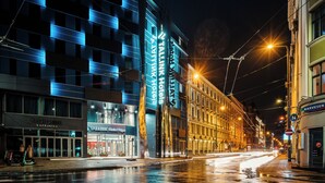 A modern hotel with a glass facade, a visible restaurant, and a tram line. - Tallink Hotel Riga  (Riga)