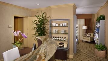Enter a serene space with a marble reception desk and comfortable seating area.