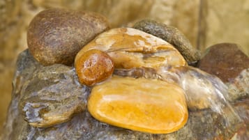 A close-up of smooth, polished stones of various shapes and sizes.