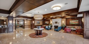 Relax in a welcoming space with comfortable seating, a fireplace, and artwork-adorned walls.