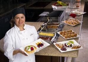 Indulge in a sumptuous spread of fresh fruits, pastries, and savory dishes at our hotel's buffet.