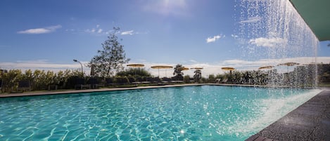 Piscine couverte, piscine extérieure, parasols de plage, chaises longues