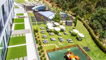Relax by the rooftop pool surrounded by a deck and scenic views of the surrounding forest.