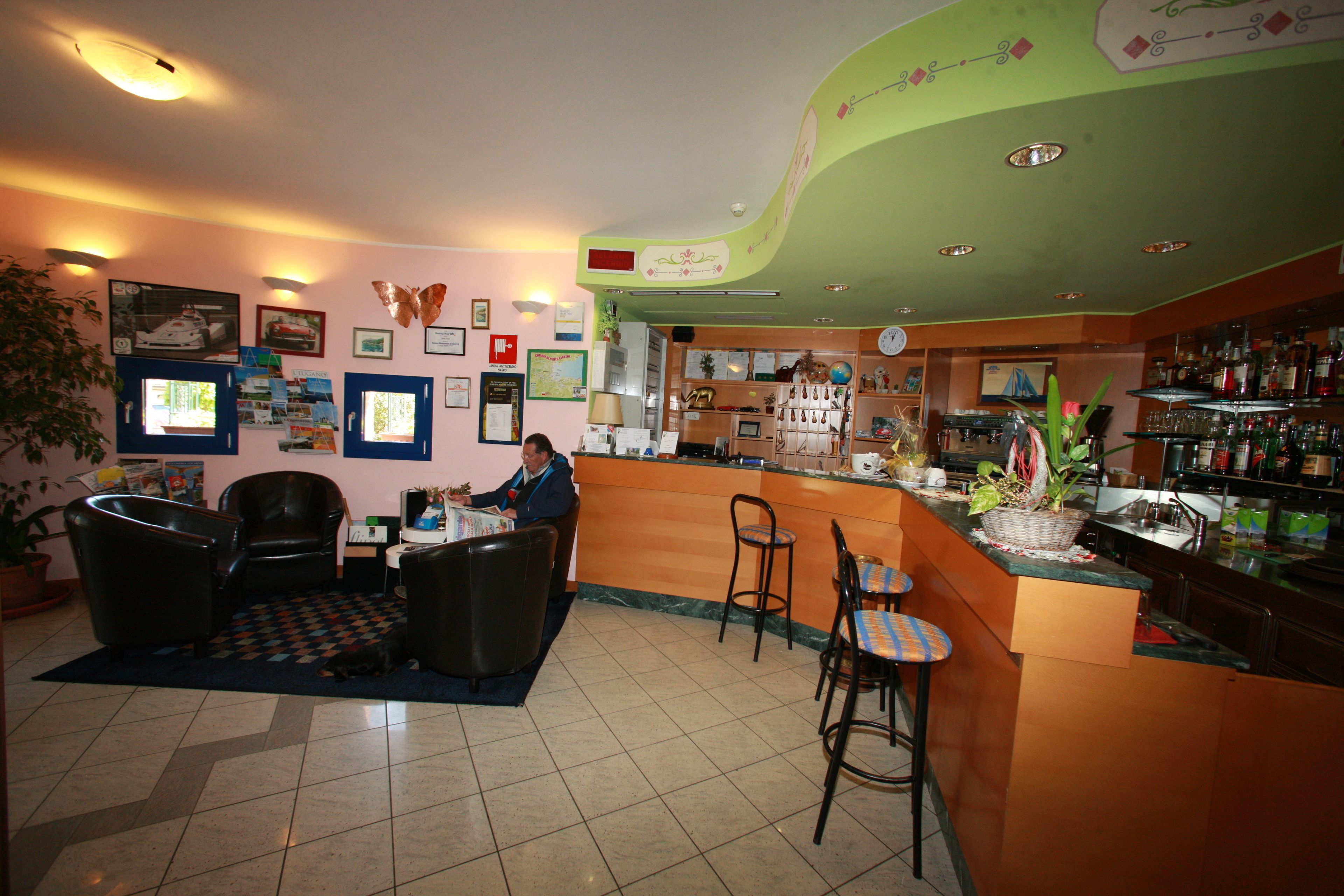 A bar area with a counter, stools, and a seating area with a patterned rug.