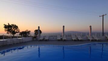 Seasonal outdoor pool, open 9:30 AM to 7:00 PM, pool umbrellas