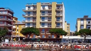 A coastal hotel with multiple balconies, a pool area, and a view of the sea. - Hotel Anita (San Bartolomeo al Mare)