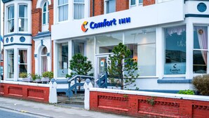 A Comfort Inn hotel with a classic red brick facade, large windows, and a prominent sign. - Comfort Inn Blackpool Gresham (Blackpool)