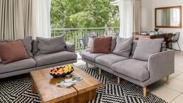 Three Bedroom Deluxe Apartment | Living room | Flat-screen TV