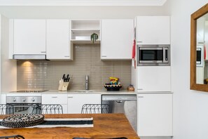 Two Bedroom Deluxe Apartment | Private kitchen | Fridge, coffee/tea maker, electric kettle