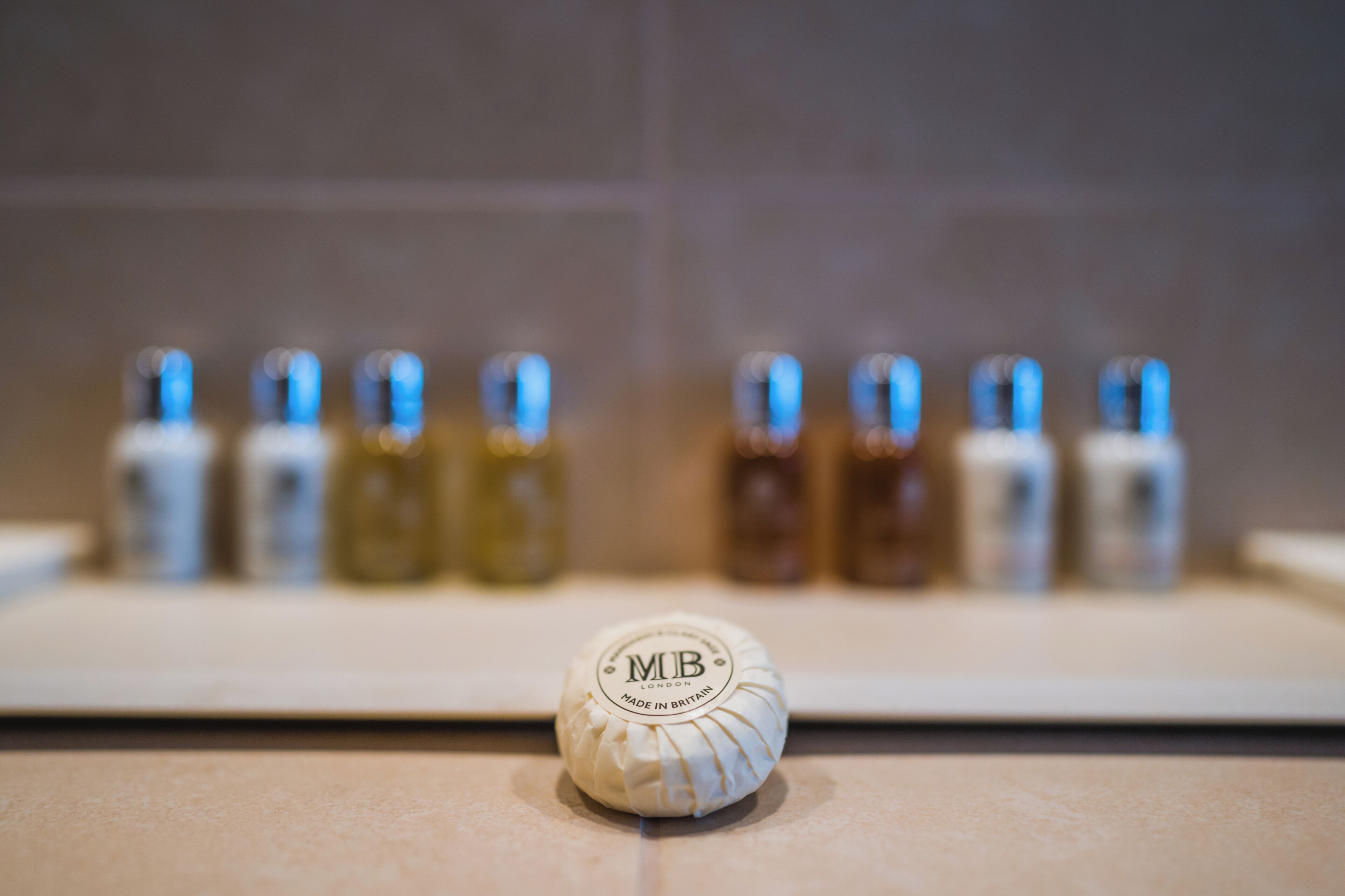 designer toiletries, hair dryer, bathrobes, slippers