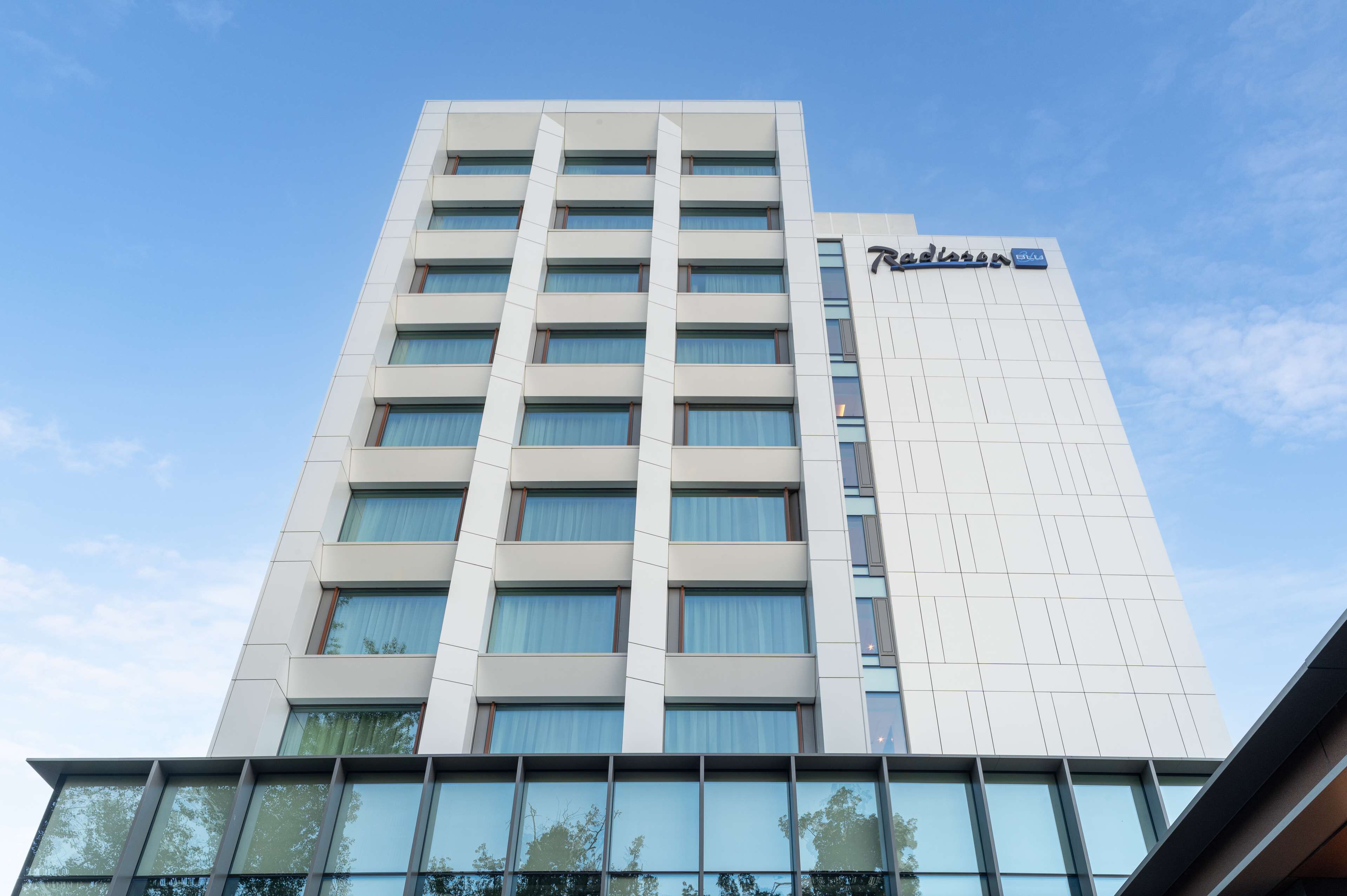 A tall, modern hotel building with a prominent sign reading "Radisson".