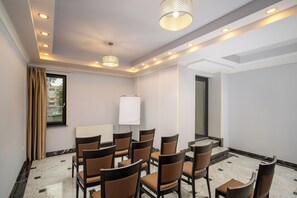 A conference room with multiple chairs, a whiteboard, and recessed ceiling lighting. - Sarmis (Deva)