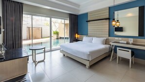 A modern hotel room with a large bed, a desk, and a view of a swimming pool. - Navinda Krabi (Krabi)