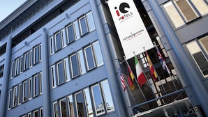 A modern hotel building with a sign for 'HOTELS' and 'La Fatalignorante Rooftop Restaurant'. - iQ Hotel Roma (Rome)