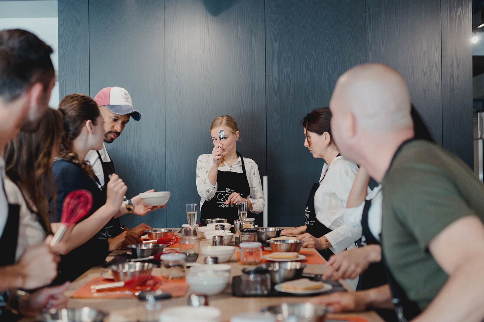 A group of people seated around a table in a room with wooden paneling.
