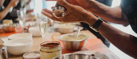 A person grating cheese over a dish.