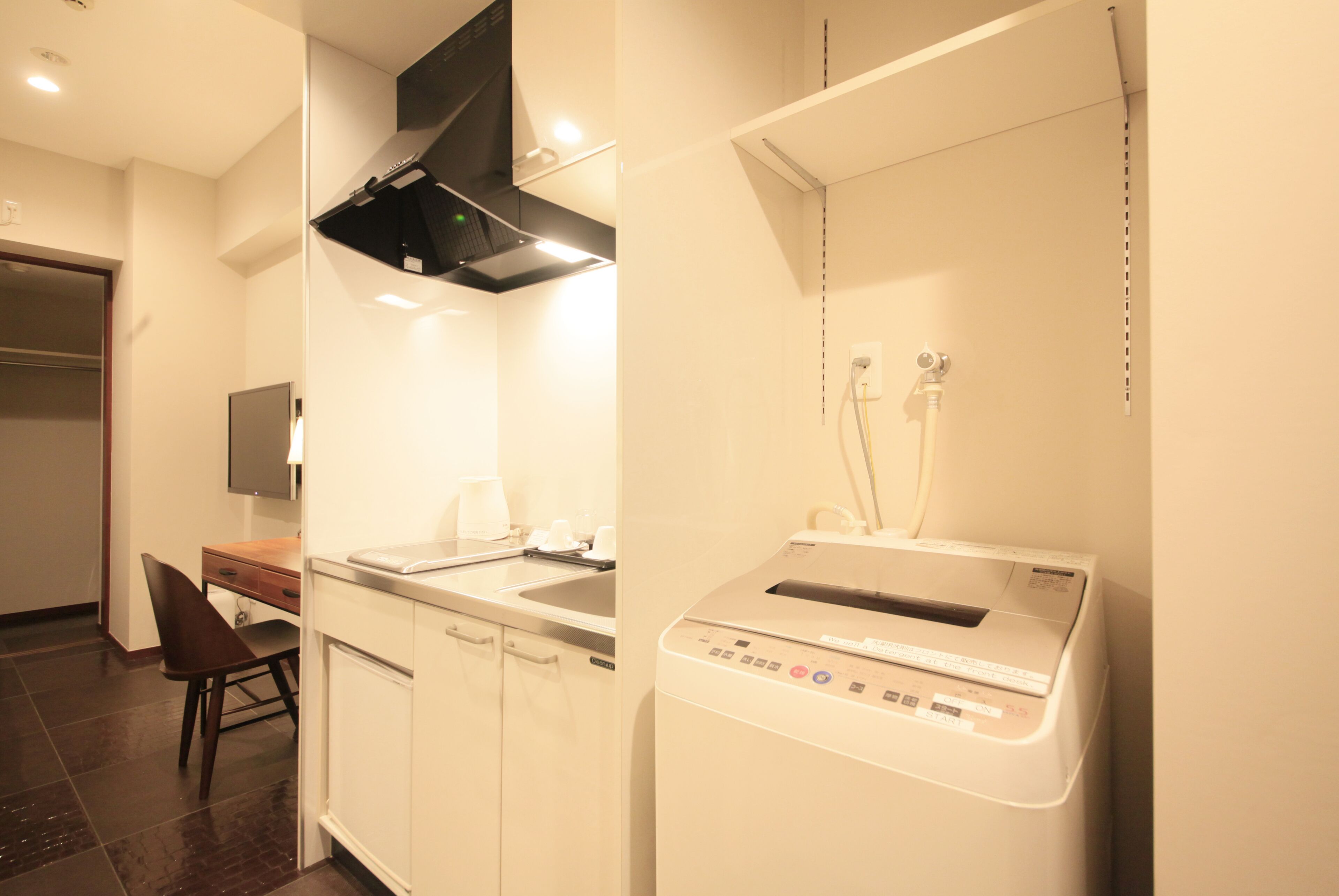 A modern kitchen with a dishwasher, a microwave, and a built-in oven.