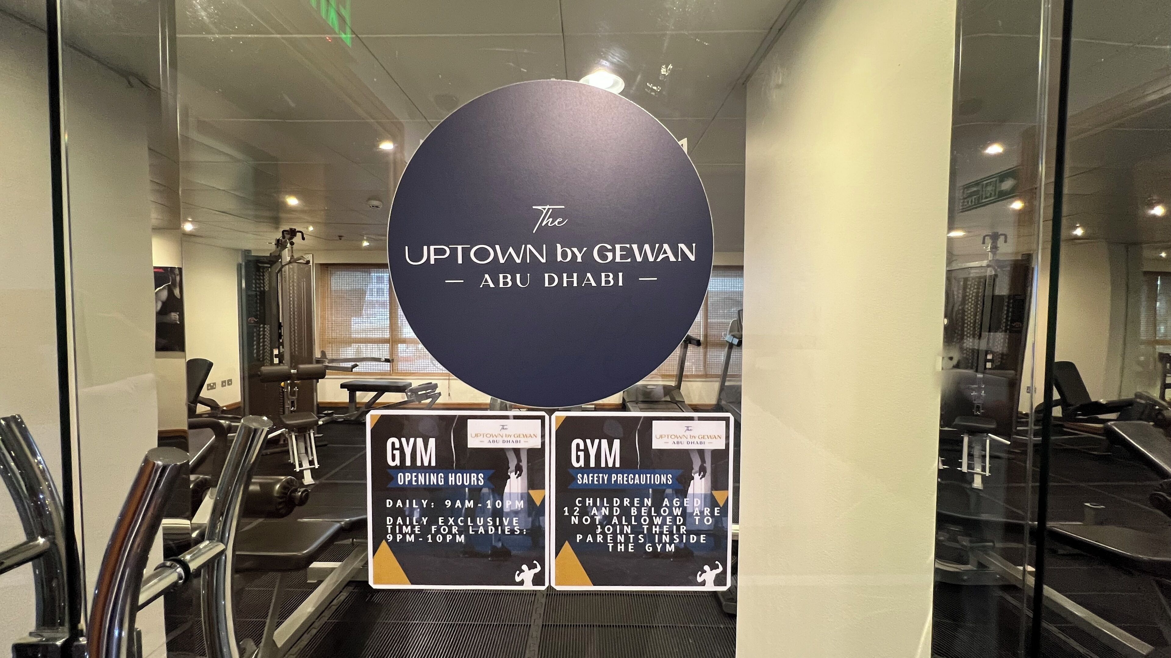 A gym area with exercise equipment and informational signs.