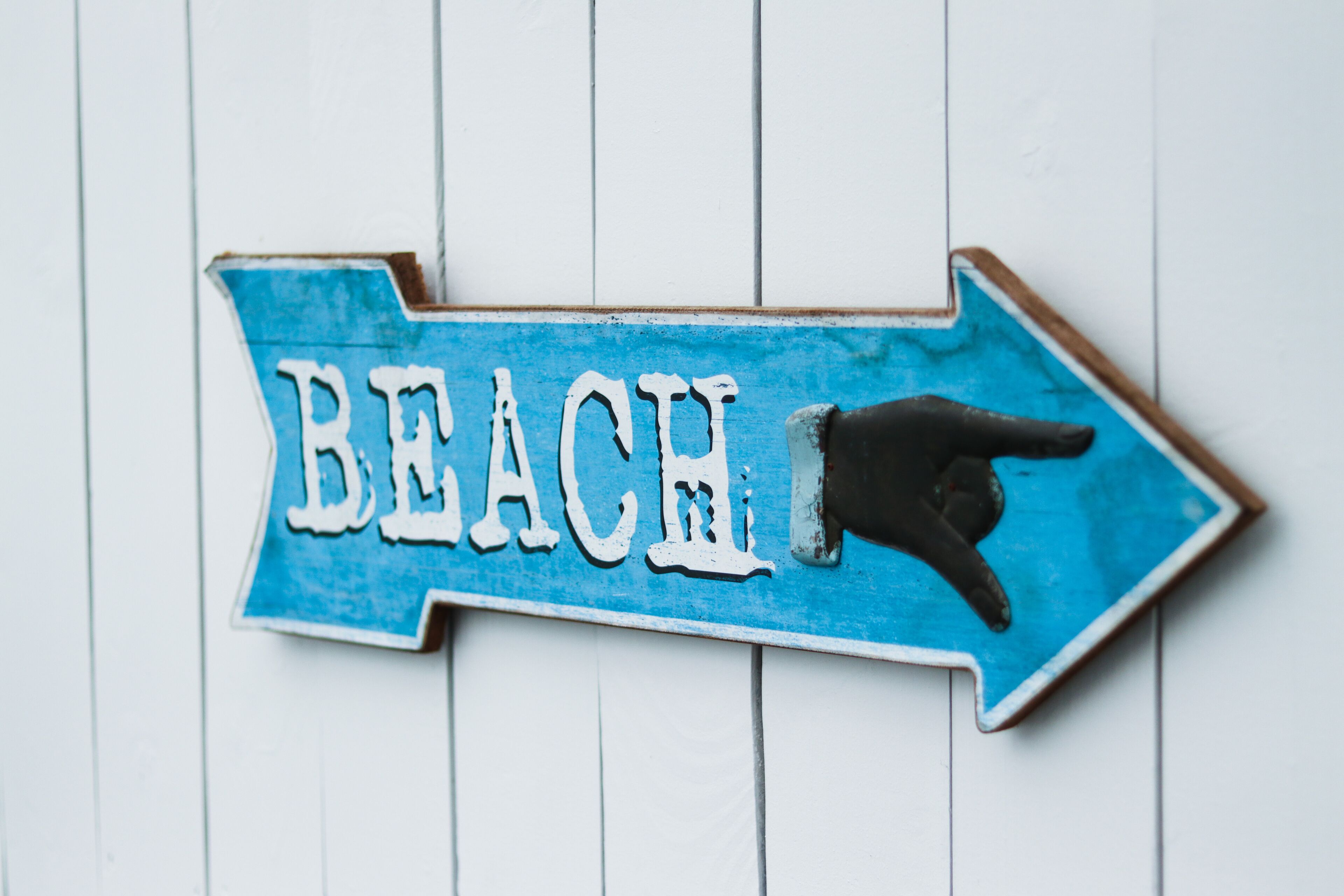 A directional sign with the word "BEACH" and an arrow pointing to the right.
