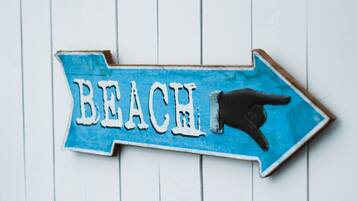 A directional sign with the word "BEACH" and an arrow pointing to the right.