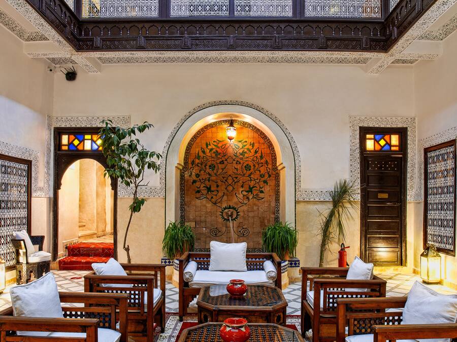 A traditional interior with wooden furniture, a balcony, and ornate decor.