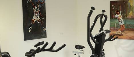 A gym with stationary bikes and exercise equipment.