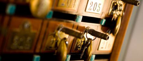 A close-up of a key rack with numbered locks, indicating a secure storage system for keys.