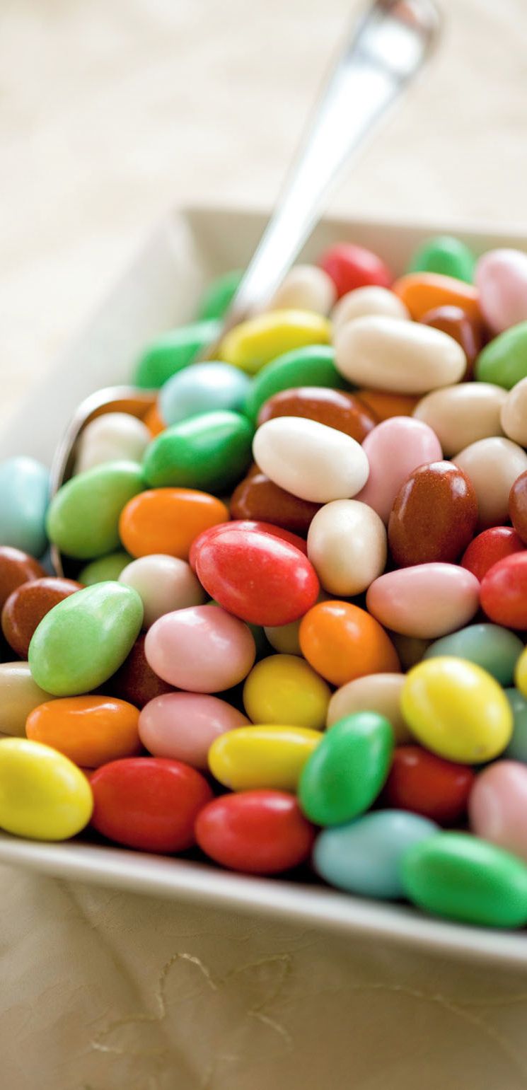 A variety of colorful candies in a container.