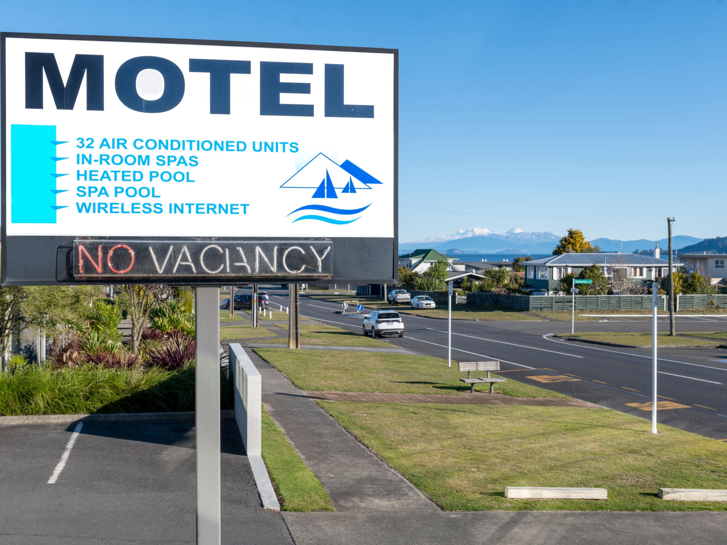 A motel sign with amenities including air-conditioned units, in-room spas, a heated pool, a spa pool, and wireless internet.