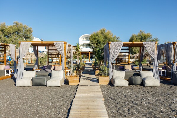 Private beach, black sand, sun loungers, beach umbrellas